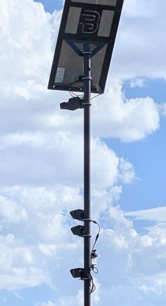Tall pole with a large solar panel showing a B logo